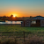 house field against sky sunset a5461